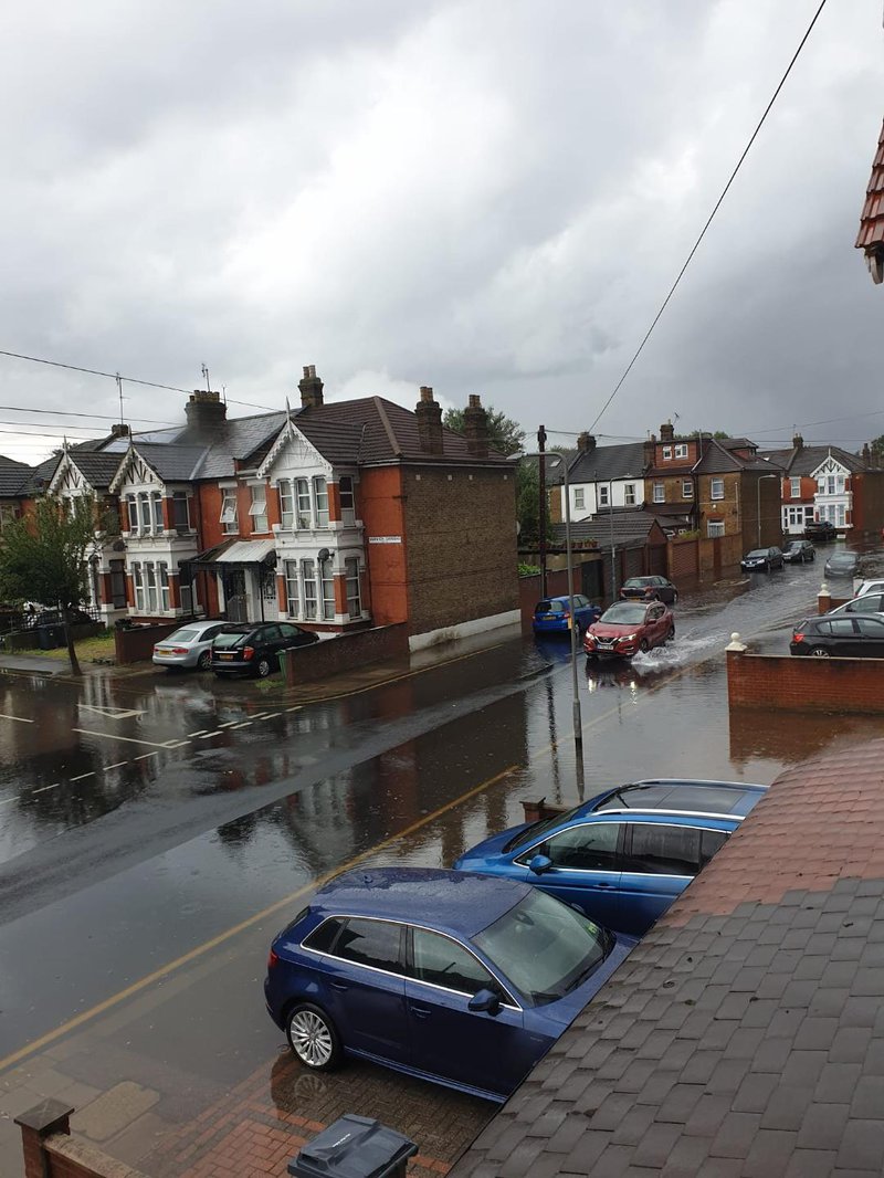 Overflowing sewage drains due to heavy rain causing water backflow on to roads in East London, July 2021