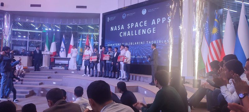 The Picture of team members, including Mr. M. Ibragimov and consultant Y. Membetsharipov from the Uzbekcosmos agency.