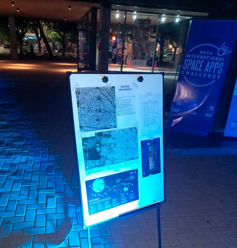 Poster with explanations of the Solar System to scale and NASA's Artemis 1 mission shown at the observation event