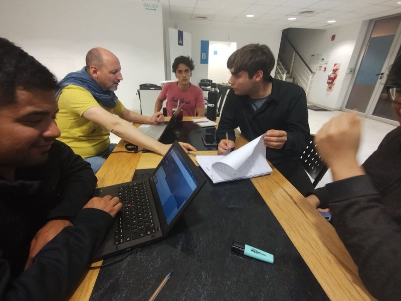 the team members discussing the roles that each will cover, this photo was taken on friday night